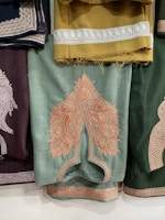 a bunch of different colored pants hanging on a wall