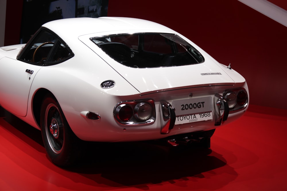 a white sports car on display at a car show