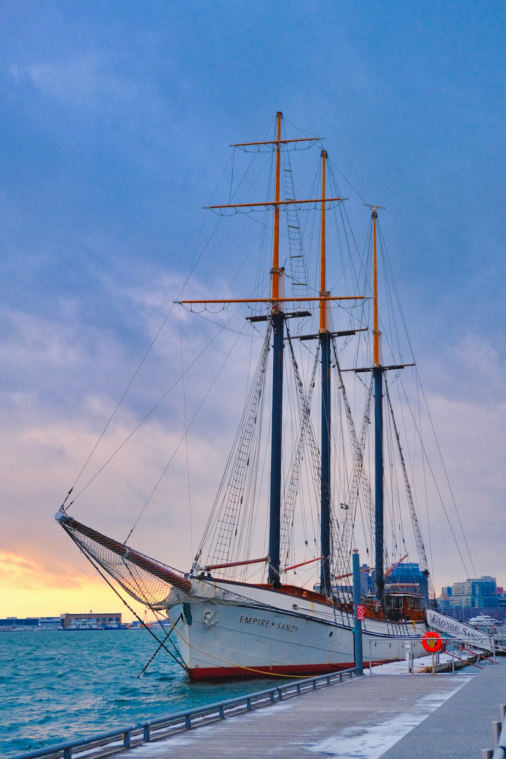 a sailboat docked at a pier in the ocean