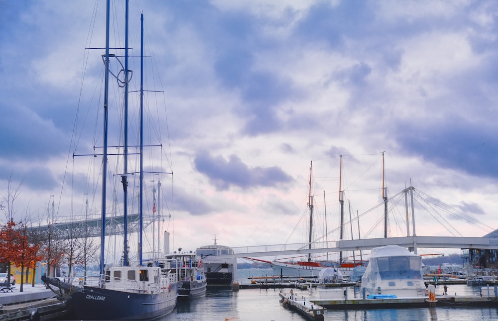 a harbor filled with lots of boats under a cloudy sky