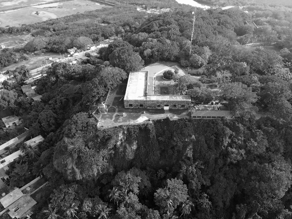 an aerial view of a building surrounded by trees