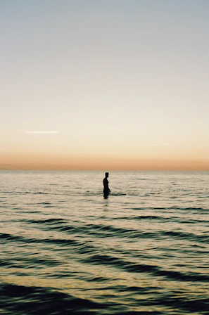 a person riding a surf board on a body of water