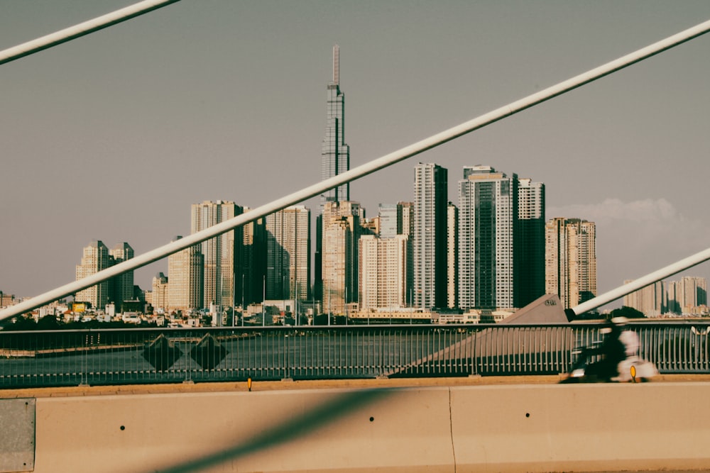 a man riding a skateboard across a bridge