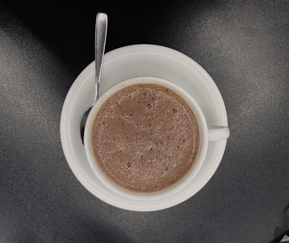 a cup of coffee with a spoon in it