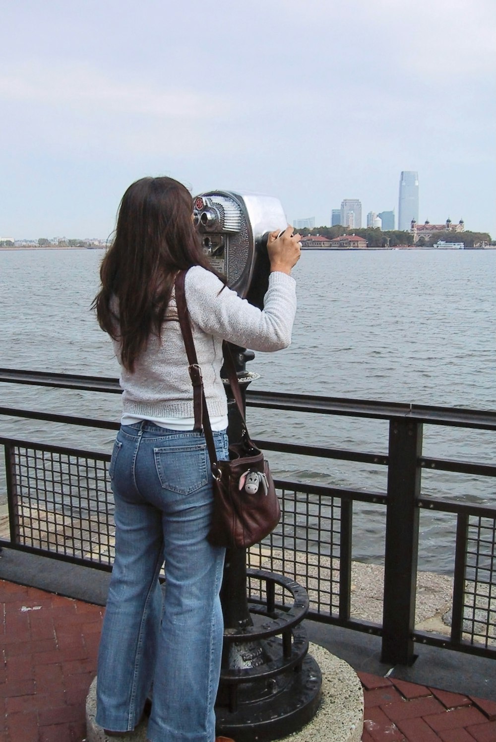 a woman taking a picture of a body of water