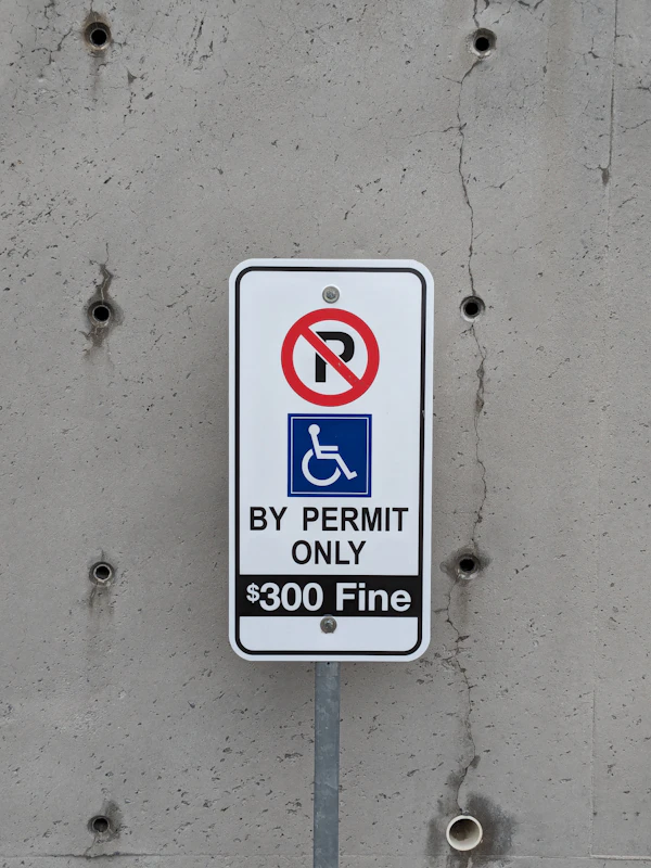 When Remodeling Permits May Be Needed: a no parking sign on a concrete wall