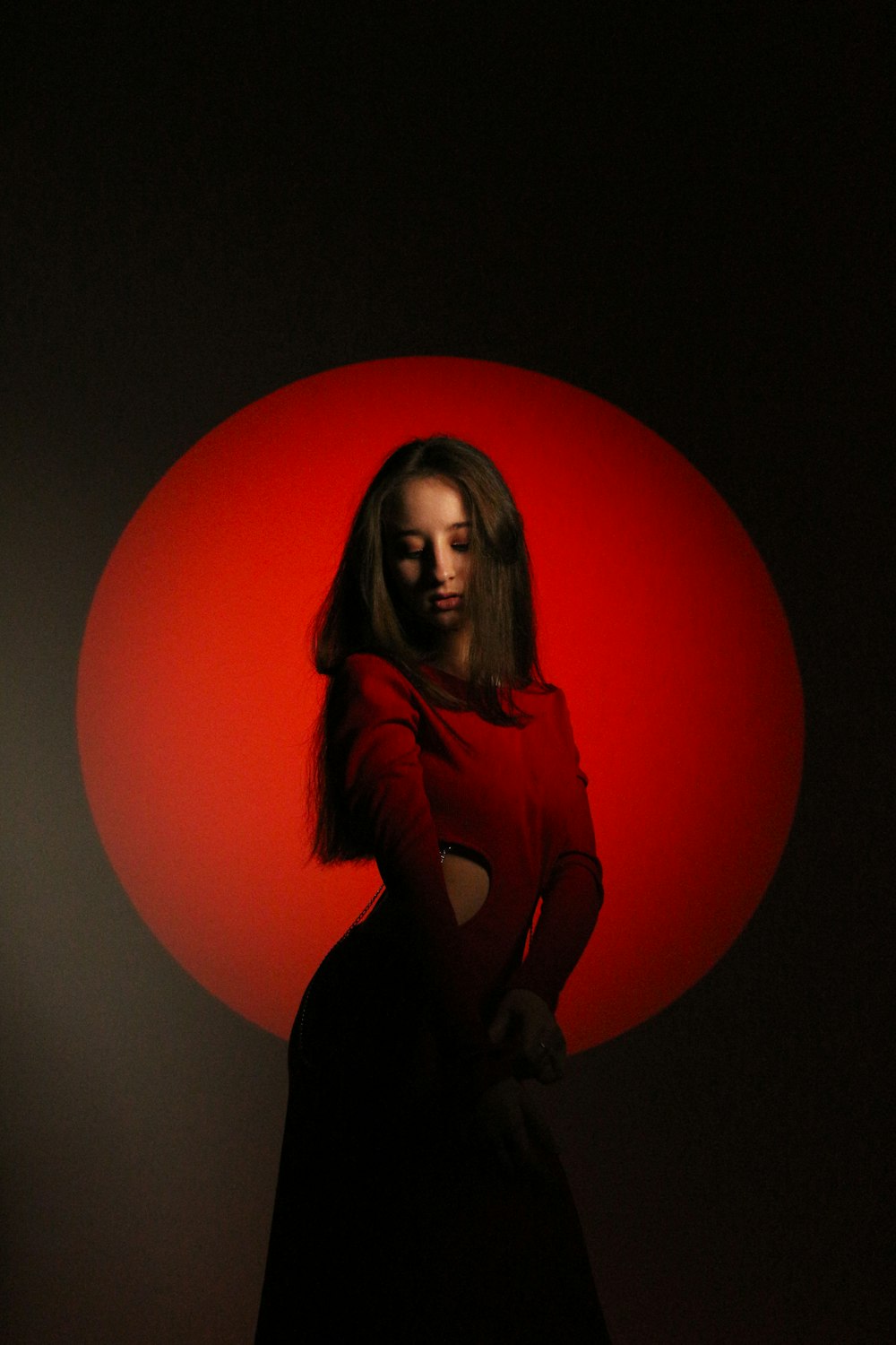 a woman standing in front of a red circle