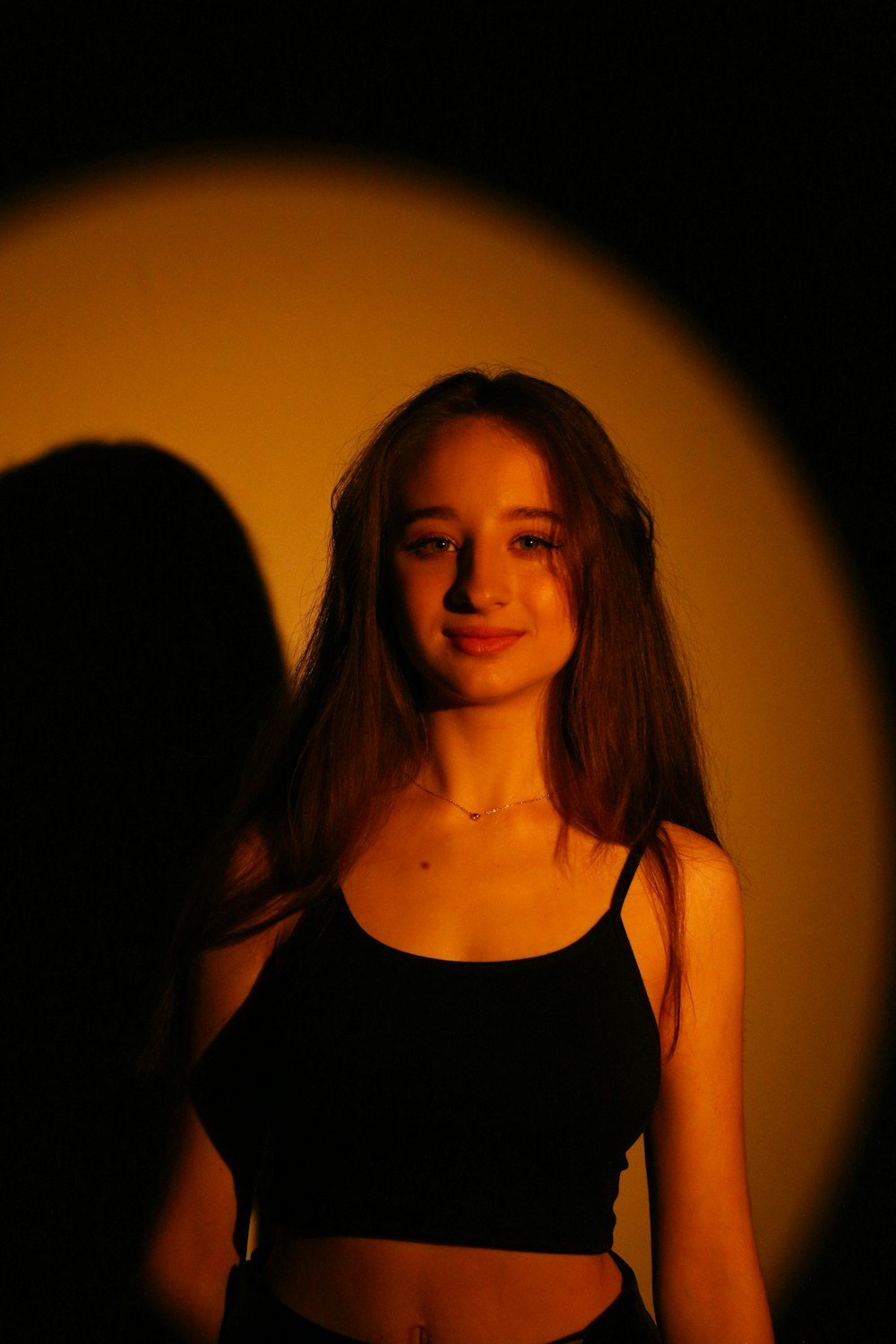 a woman standing in front of a dark background