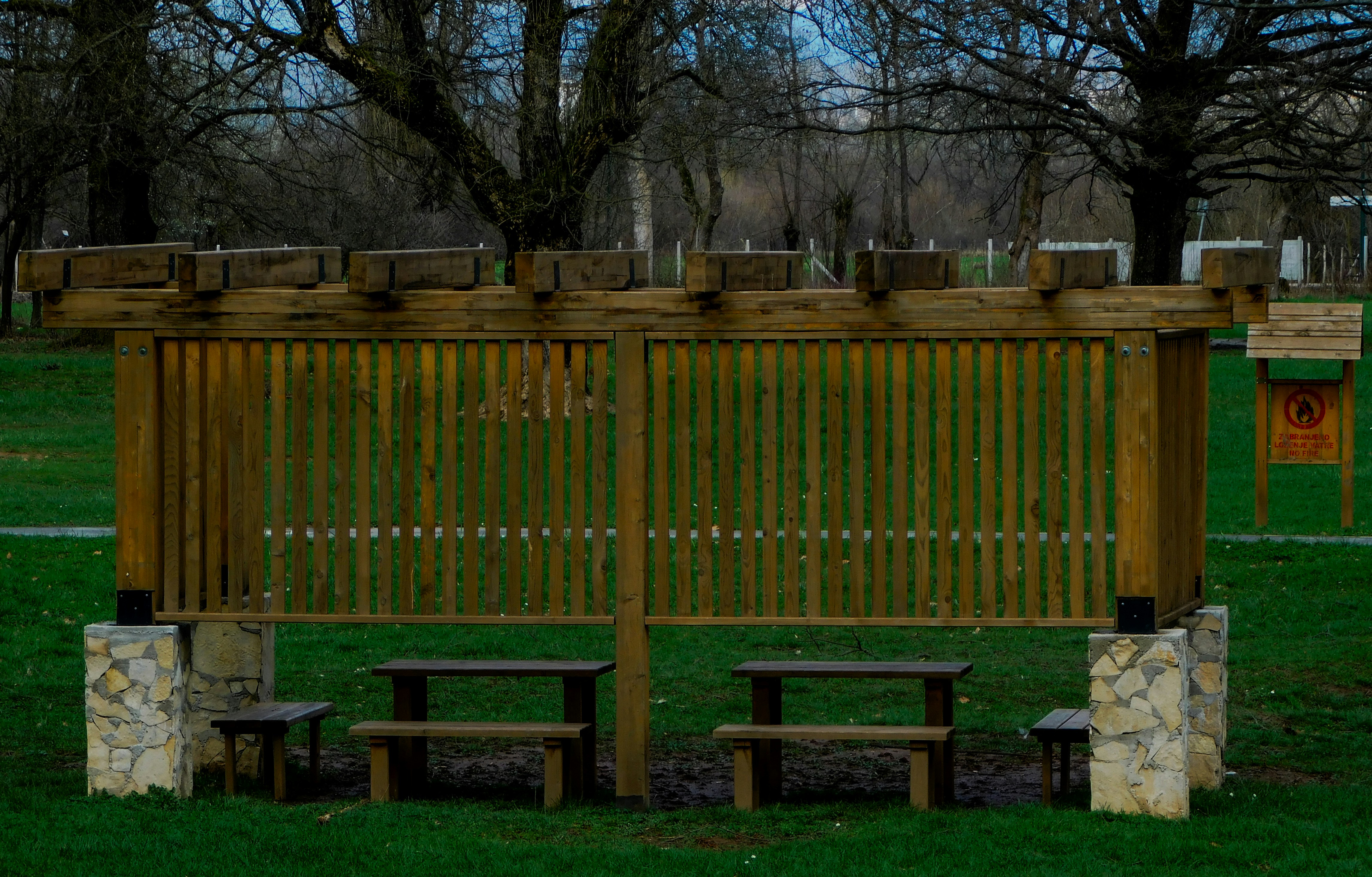 Wooden picnic shelter on a lawn