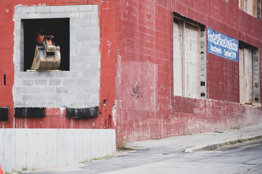 a red brick building with a small window on the side of it