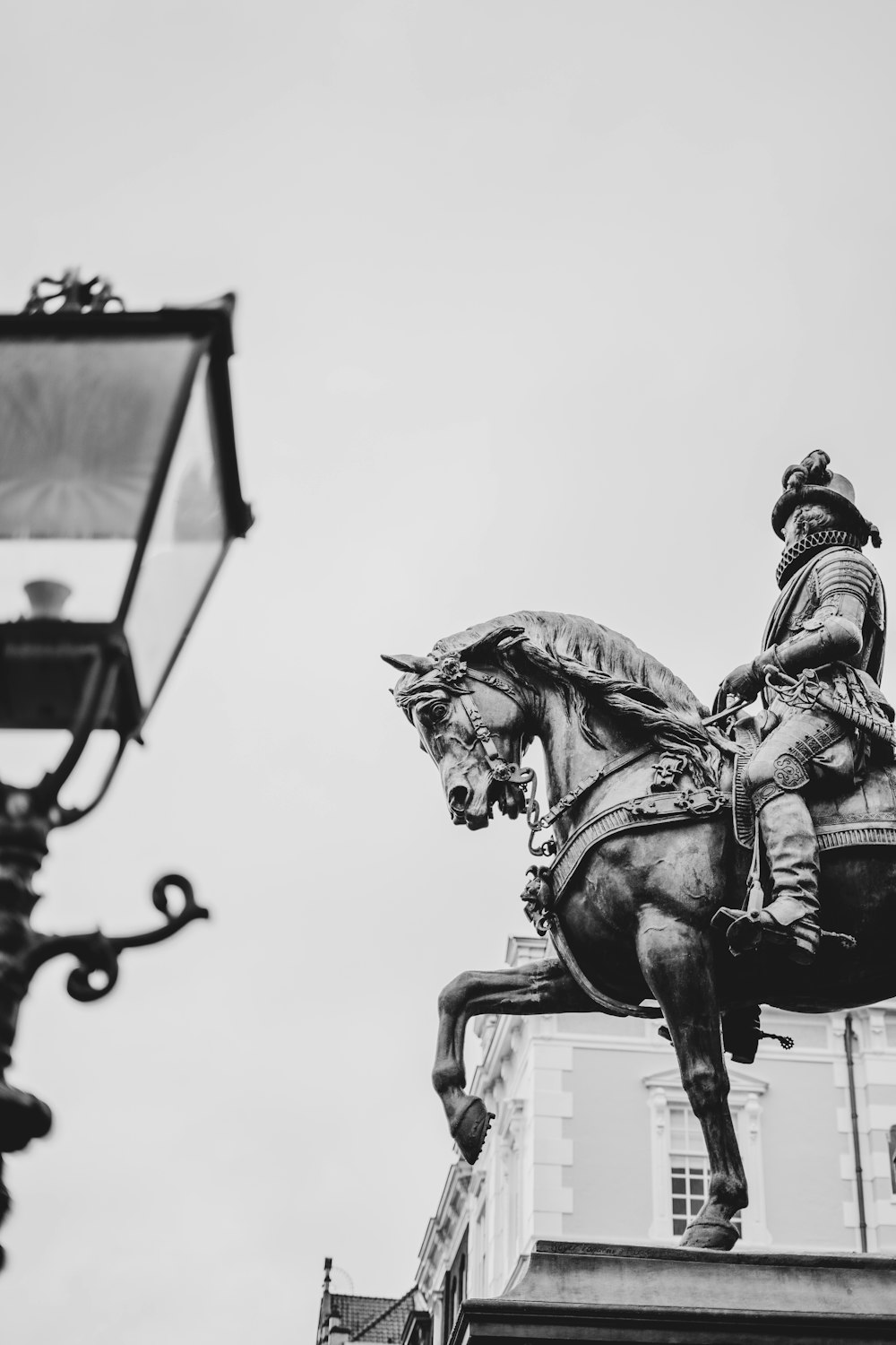 a black and white photo of a statue of a man on a horse