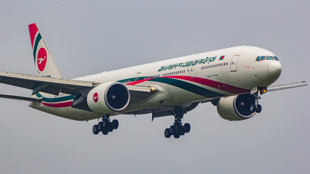 a large jetliner flying through a cloudy sky