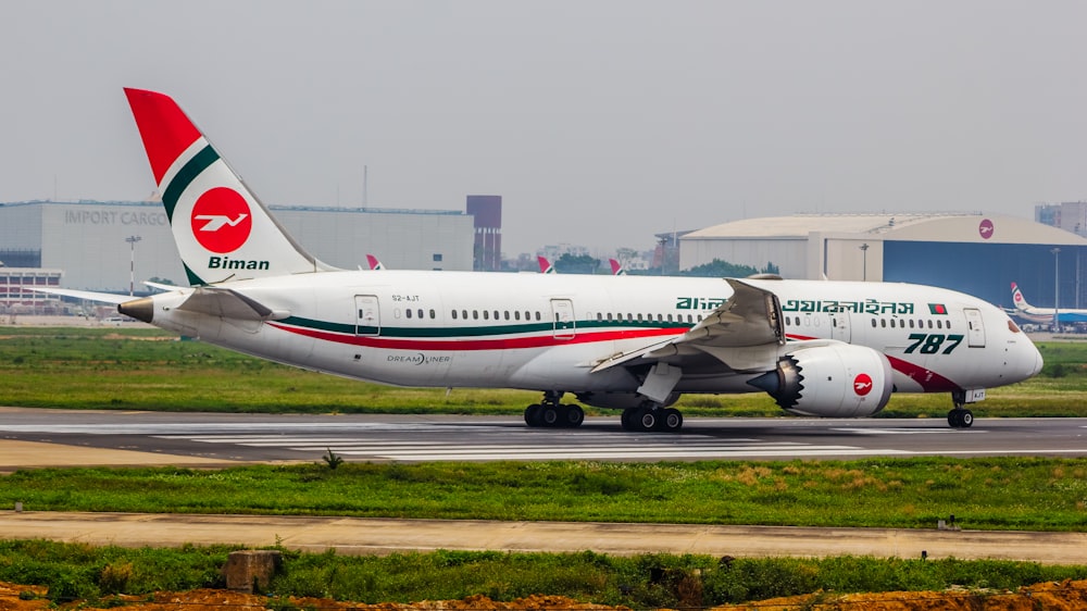 a large jetliner sitting on top of an airport runway