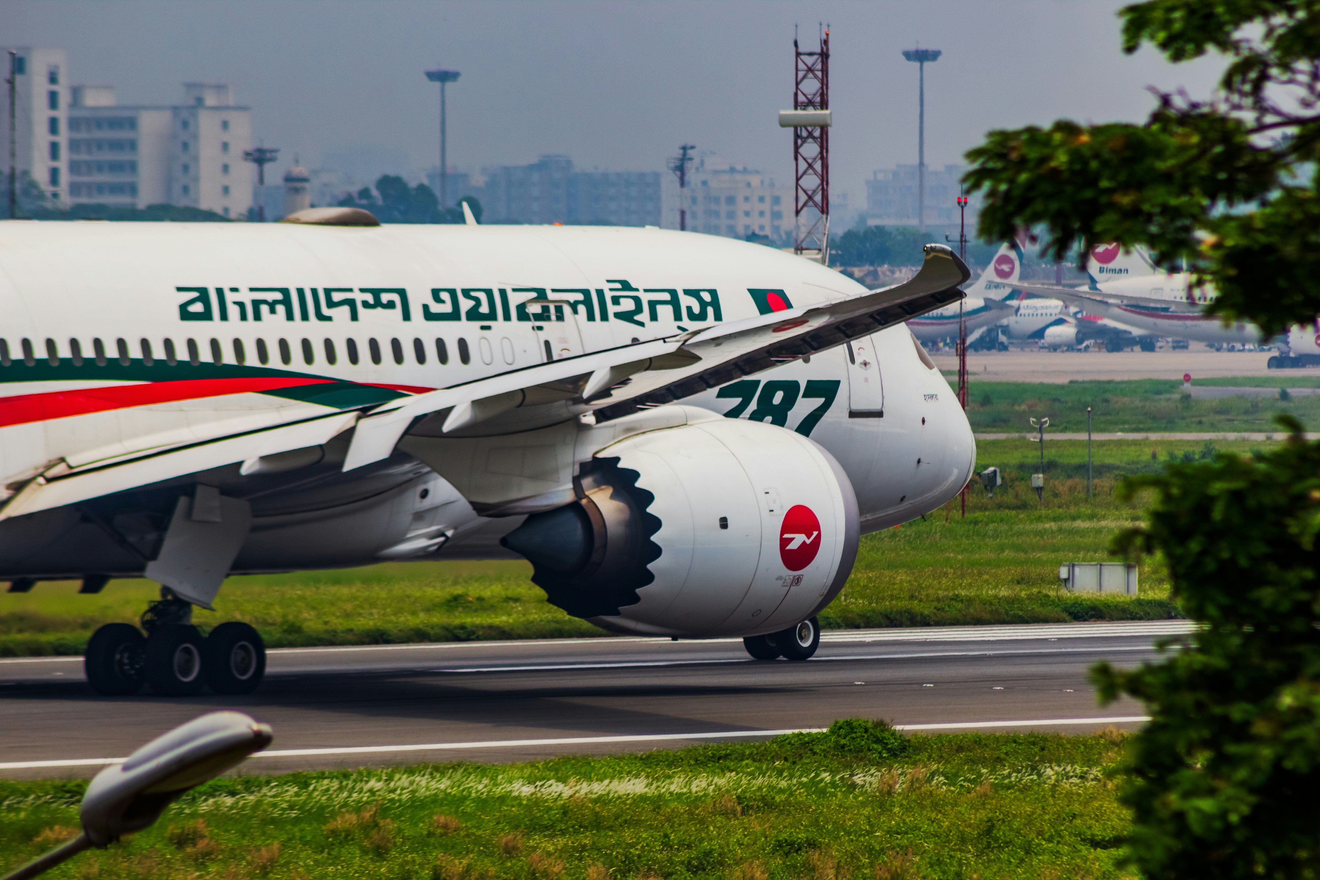 a large jetliner sitting on top of an airport runway, Bangladesh Airlines Boeing 787 dreamliner preparing to takeoff