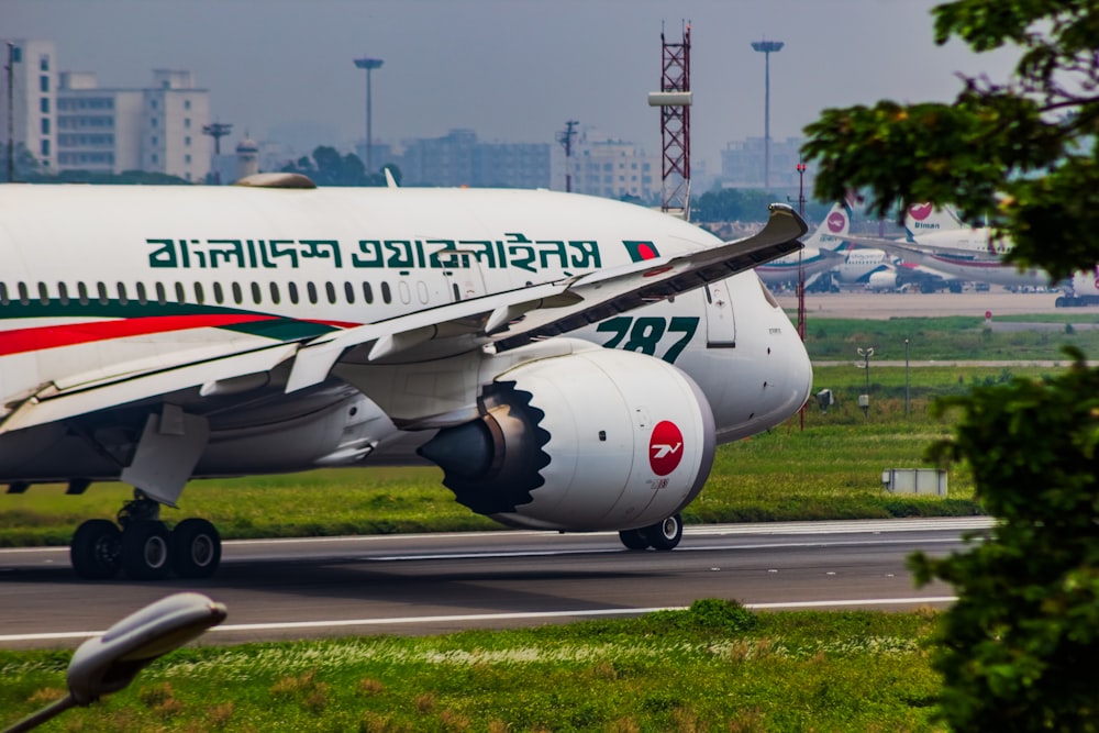 a large jetliner sitting on top of an airport runway