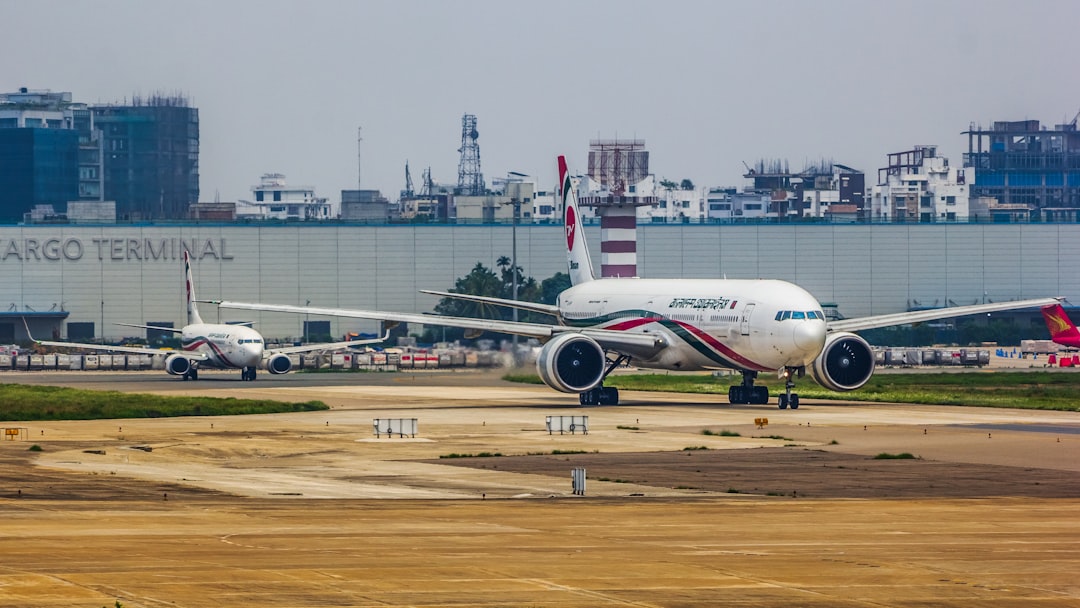 a large jetliner sitting on top of an airport tarmac, Biman Bangladesh Airlines | Boeing 777-300ER and Boeing 737-800