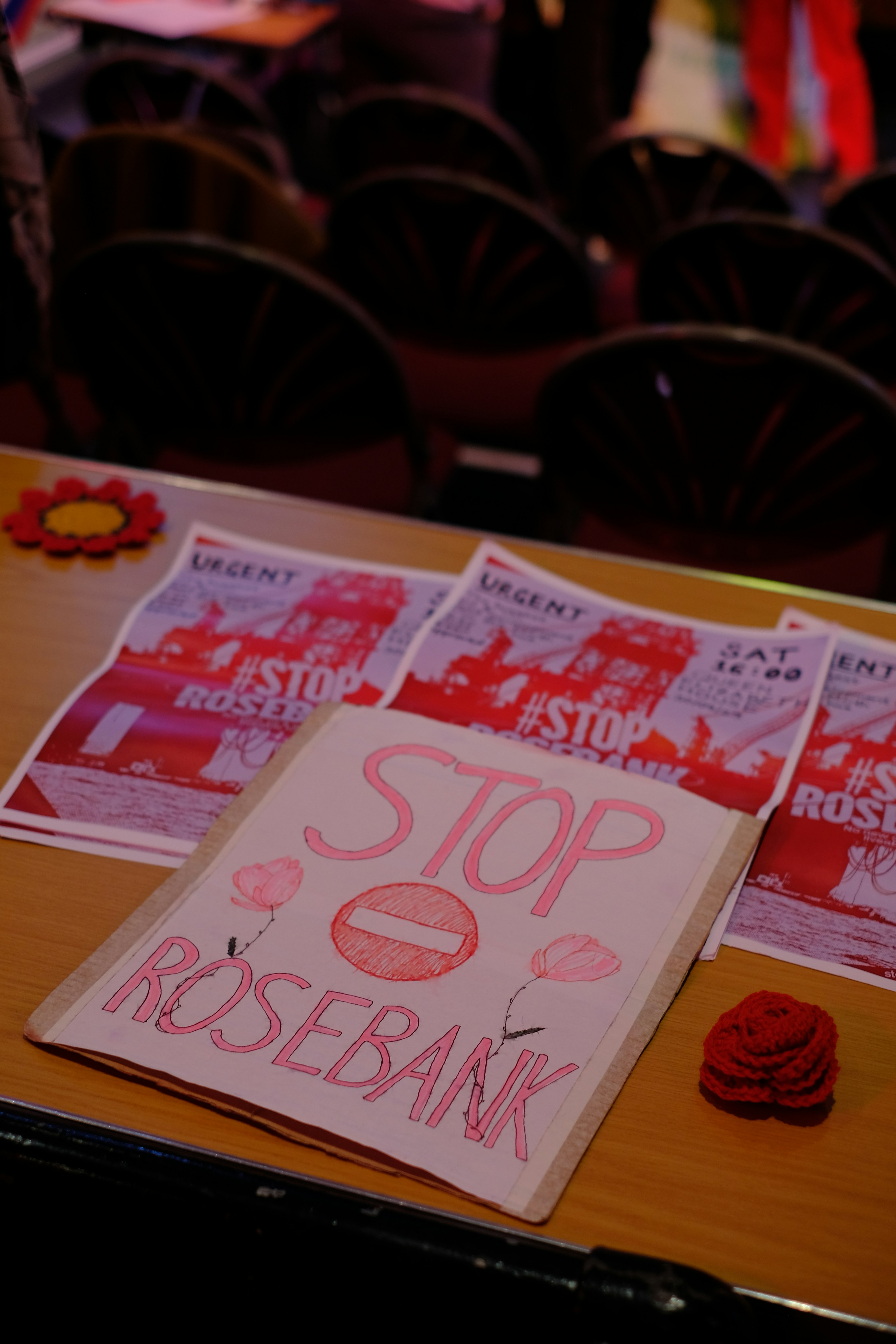 a wooden table topped with lots of red paper