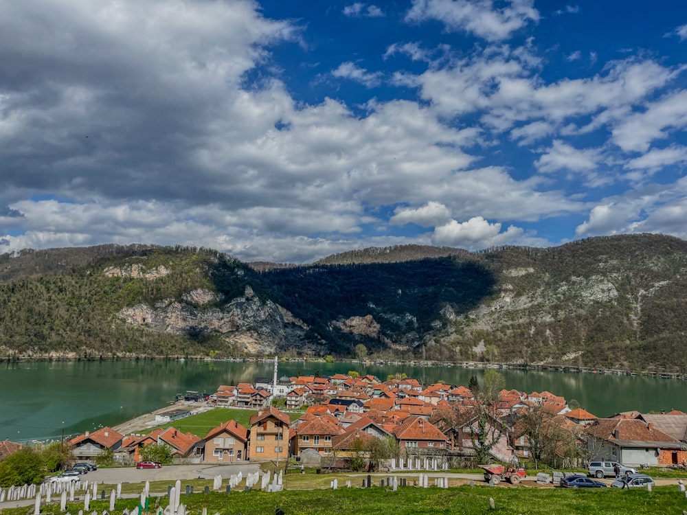 a scenic view of a village and a lake