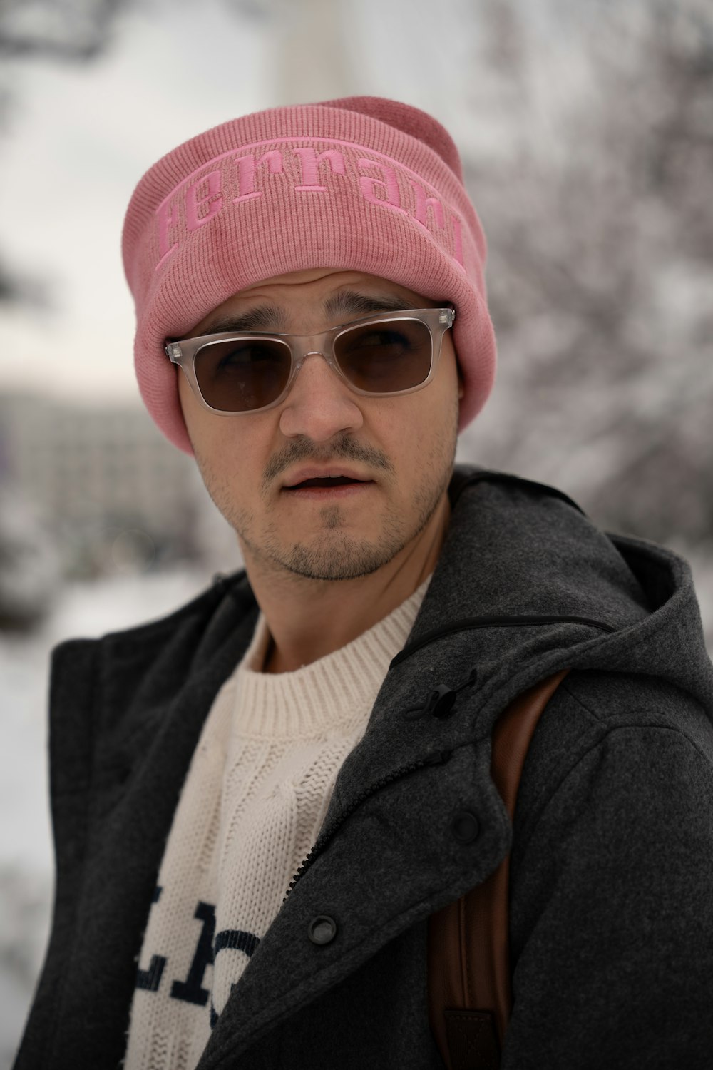 a man wearing a pink hat and sunglasses