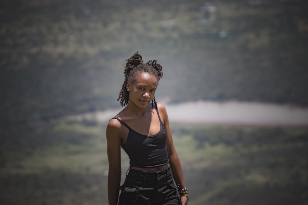 a woman with braids standing in a field