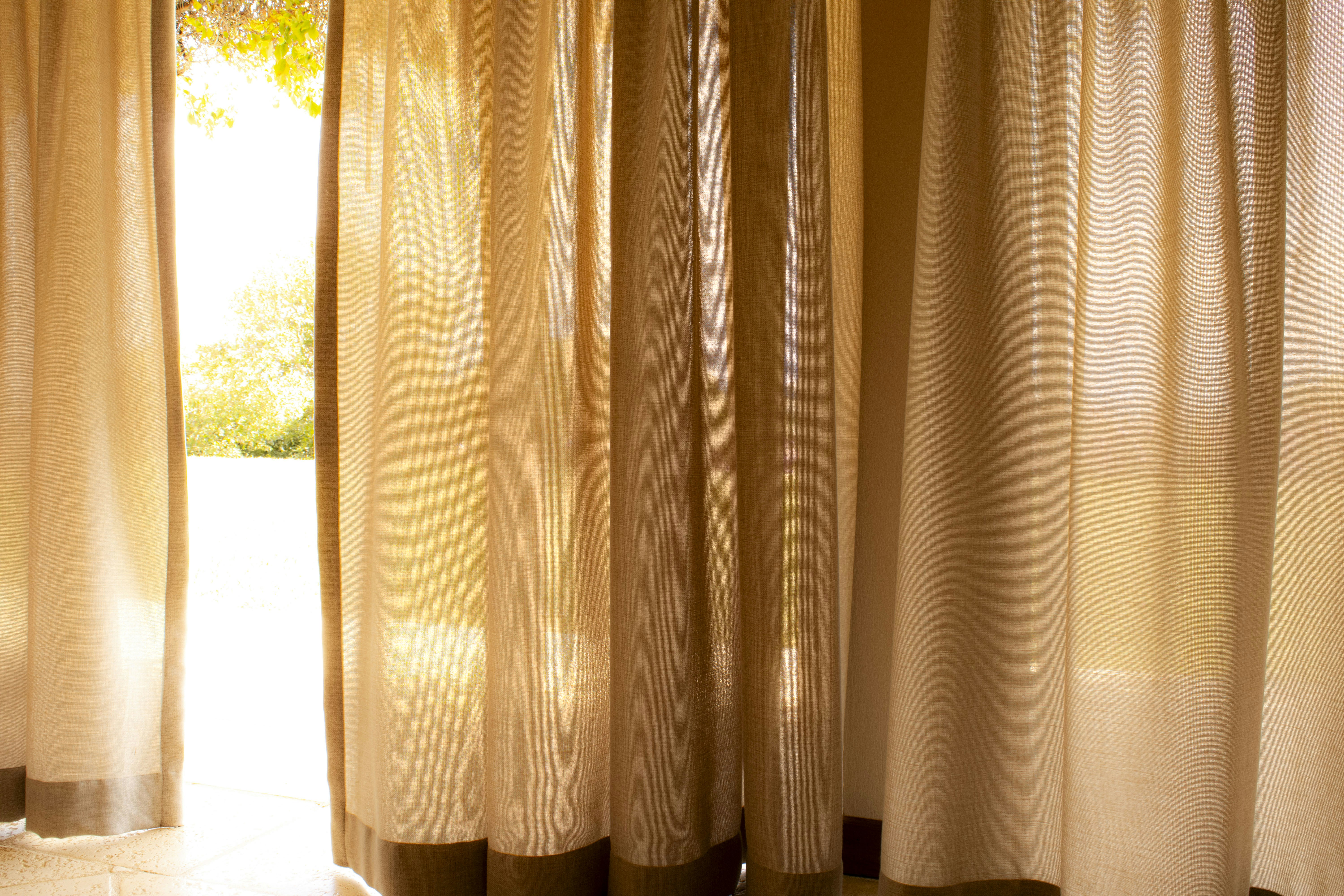 Heavy velvet curtains installed on a tension rod in a bedroom - budget bedroom echo reduction