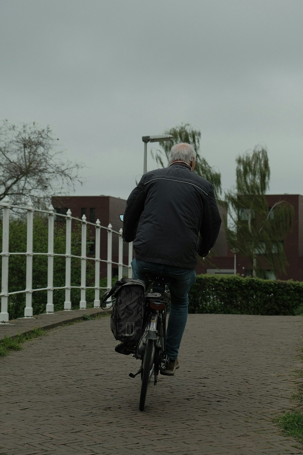 a man riding a bike down a sidewalk