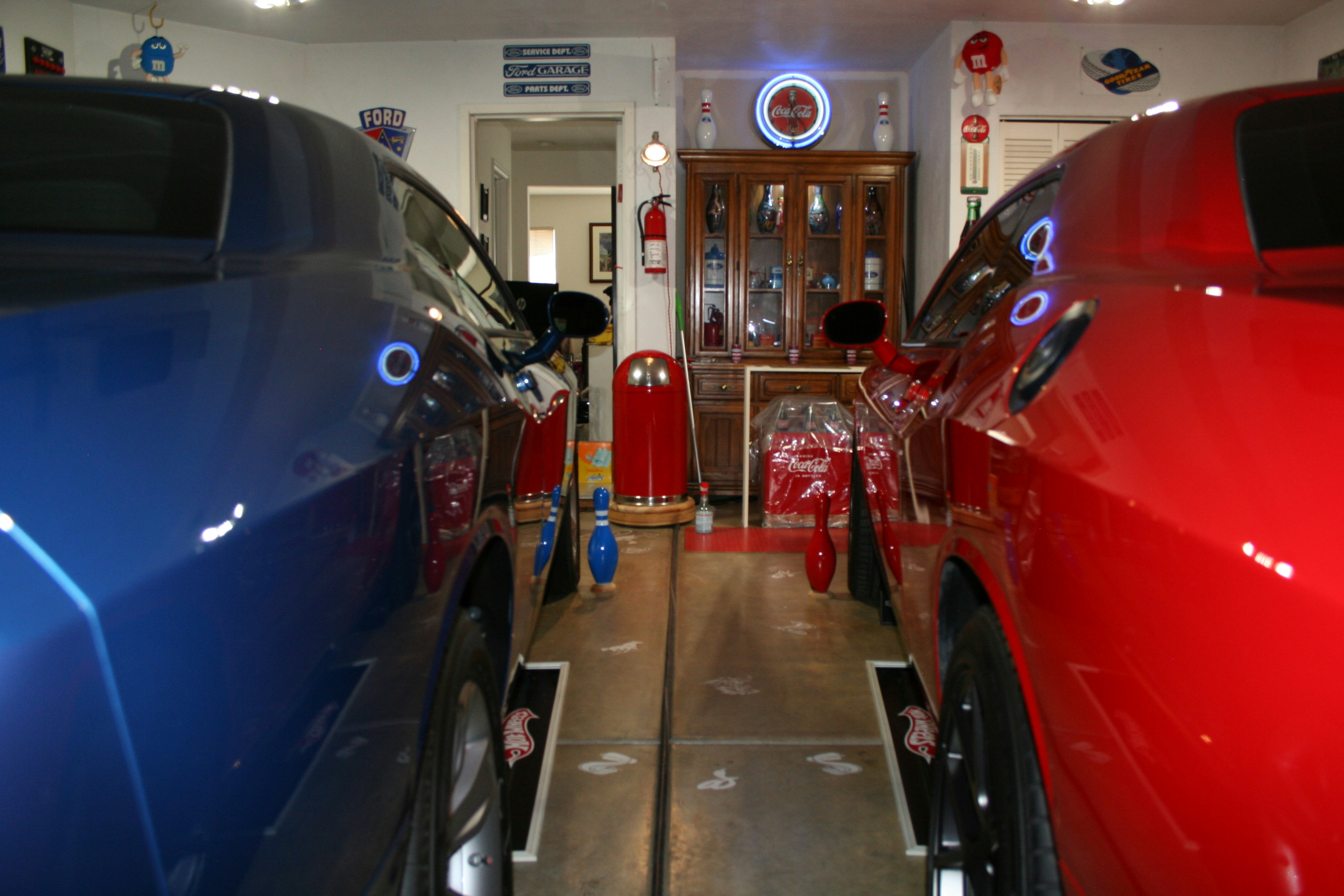 Technician inspecting an electric vehicle in a service bay