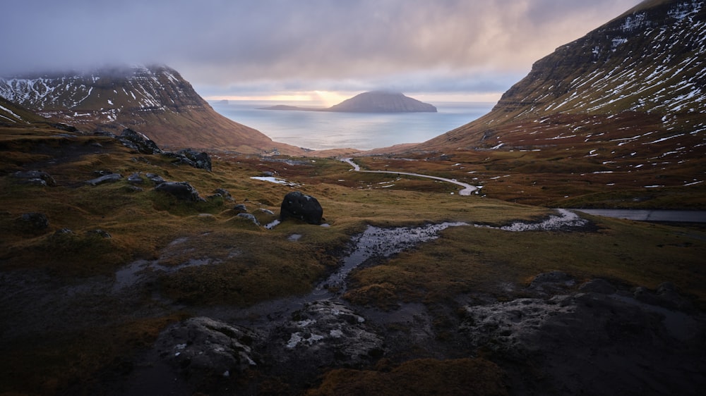 a view of a mountain range with a body of water in the distance