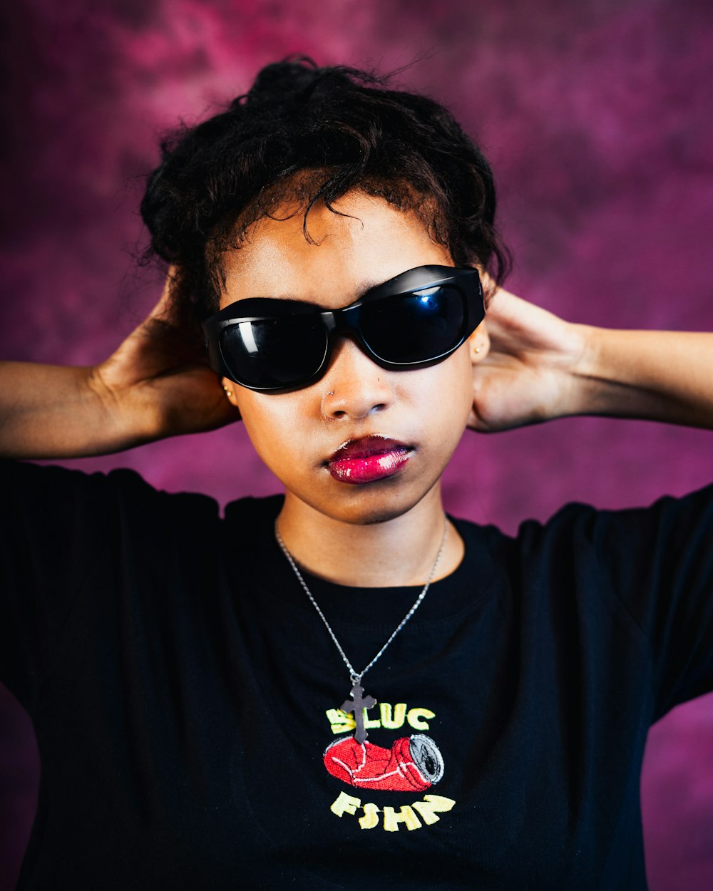 a woman wearing sunglasses and a black shirt