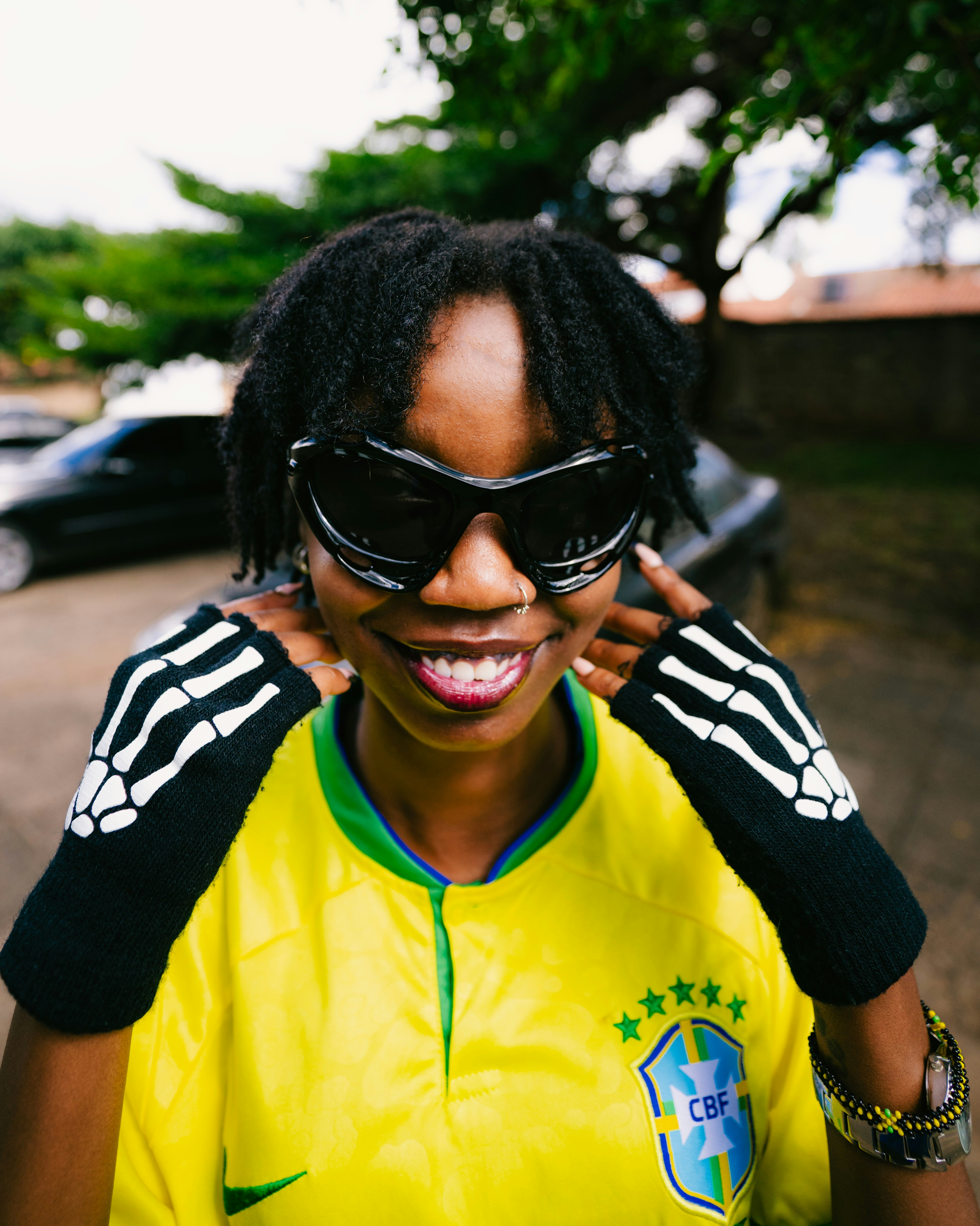 A woman wearing a yellow shirt and black sunglasses photo – Free ...