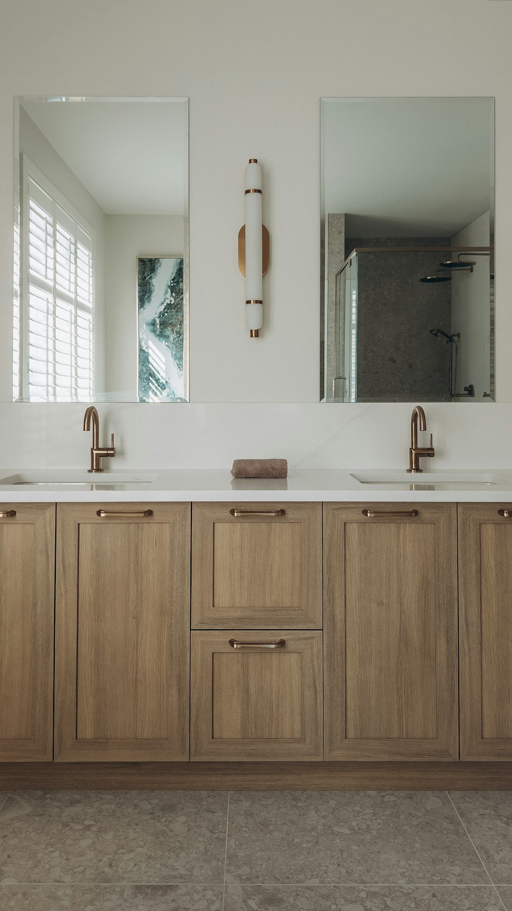 a bathroom with two sinks and a large mirror