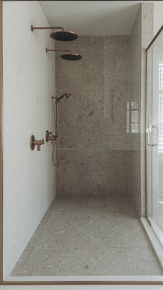 a walk in shower sitting next to a window