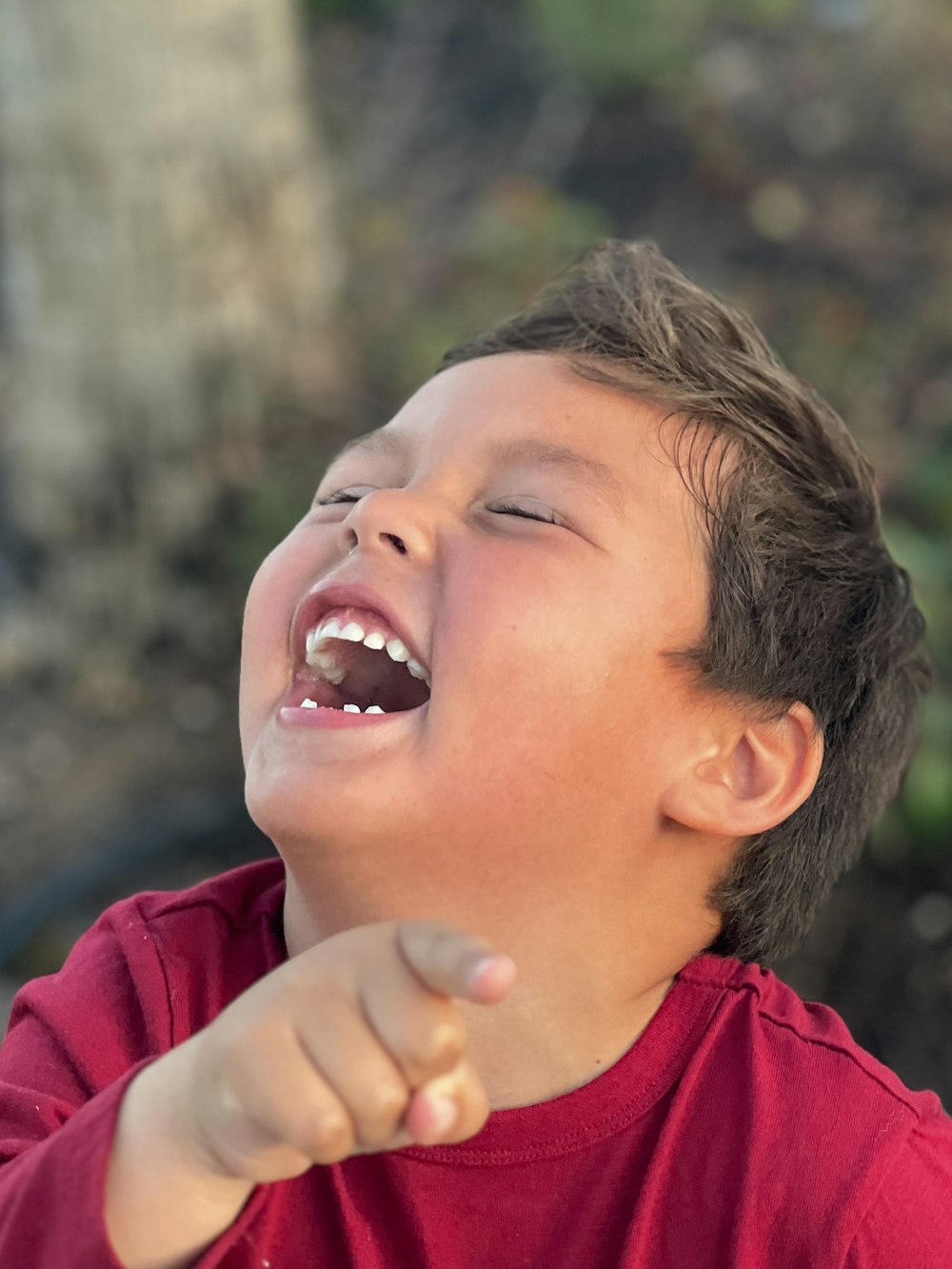 a young boy with his mouth open and a toothbrush in his hand