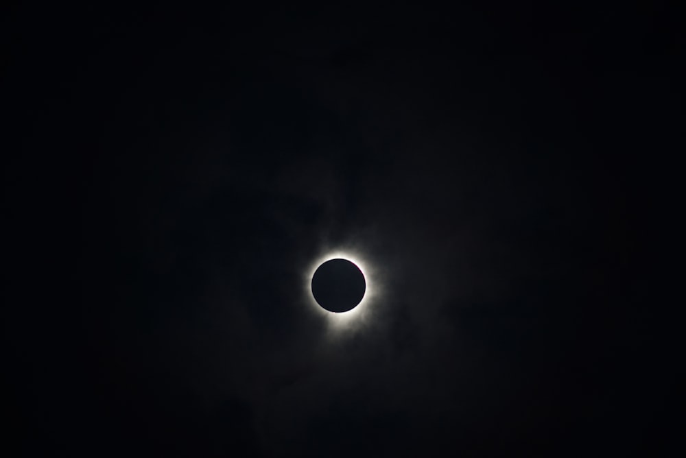 a solar eclipse is seen in the dark sky