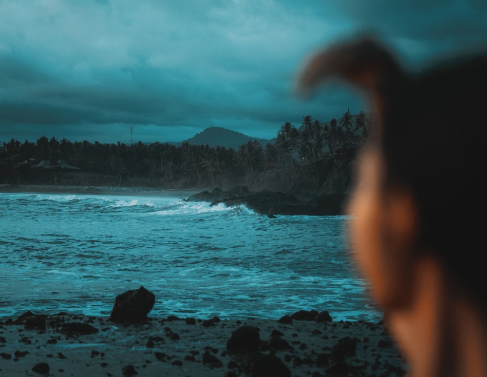 a blurry photo of a person standing on a beach