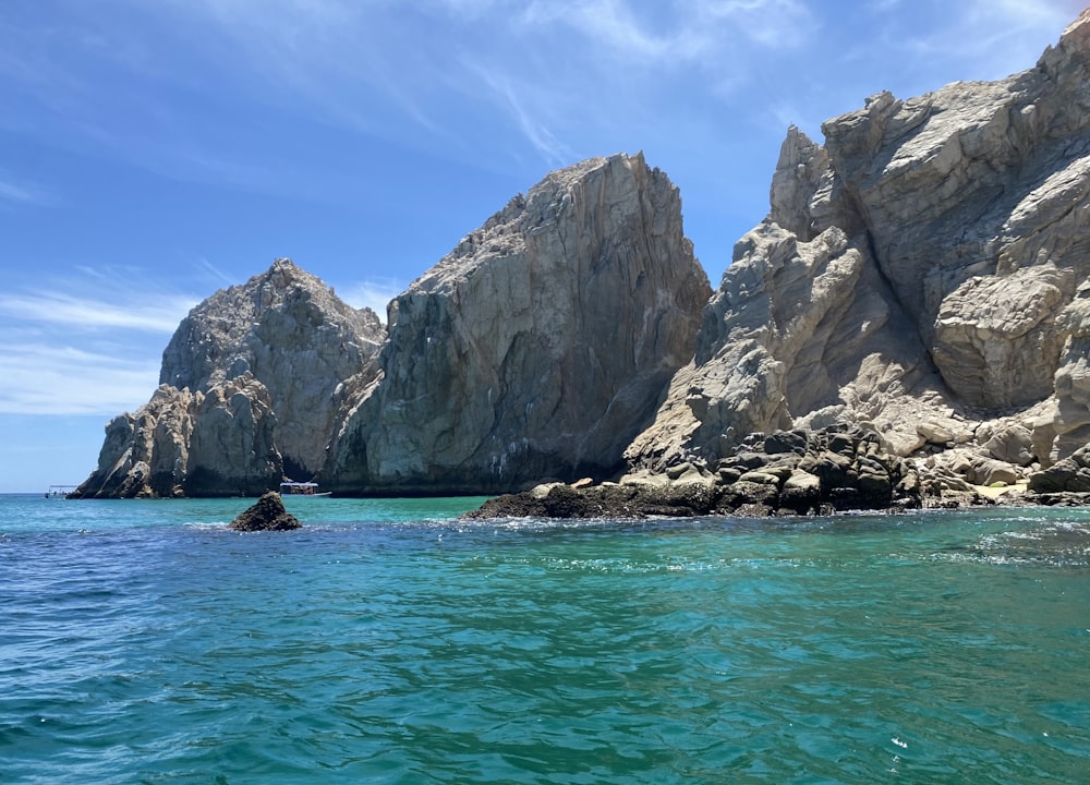 a rock formation in the middle of a body of water