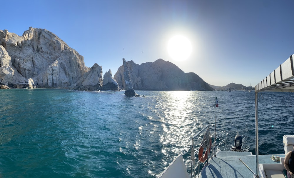 the sun shines brightly on a boat in the water