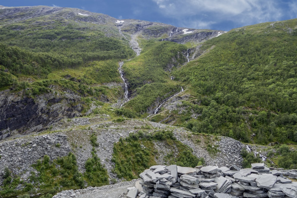 a view of a mountain with a waterfall in the distance