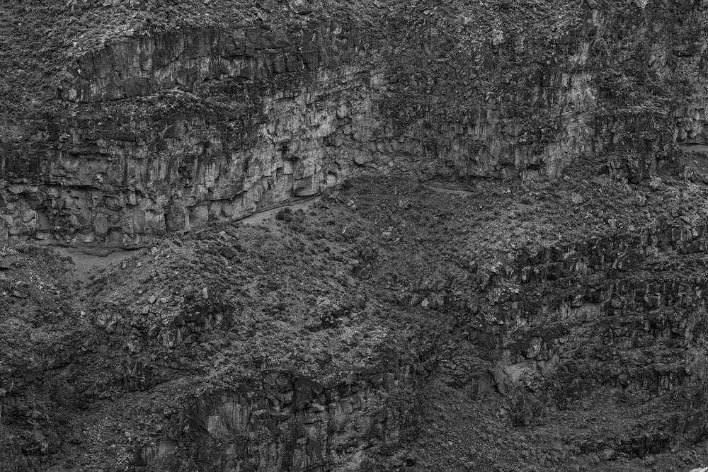 a black and white photo of a mountain side