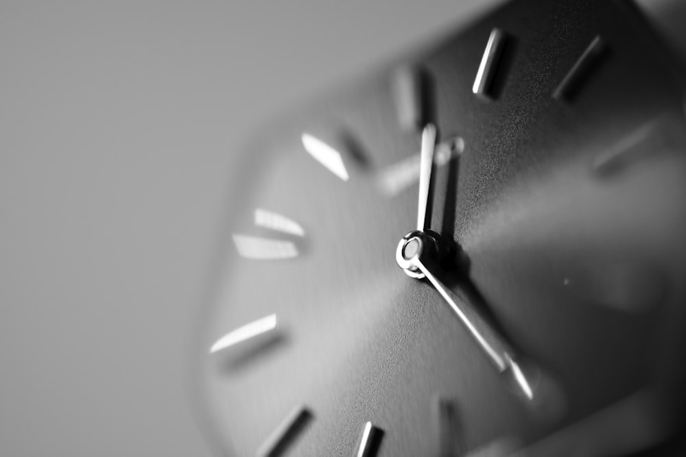 a black and white photo of a clock face