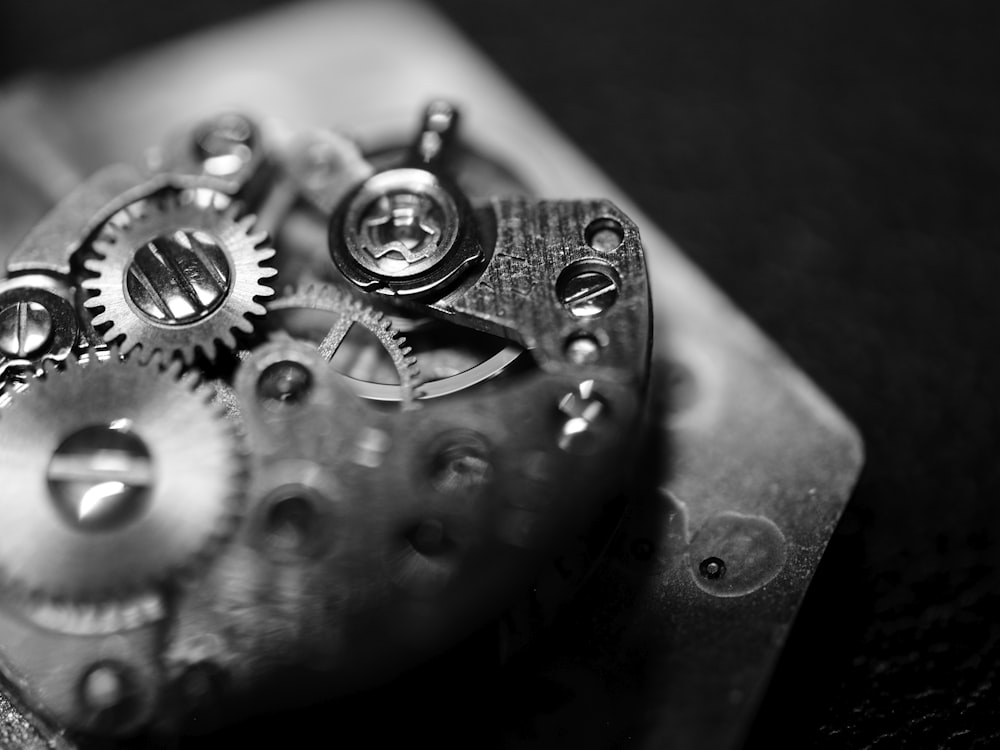 a black and white photo of a watch movement
