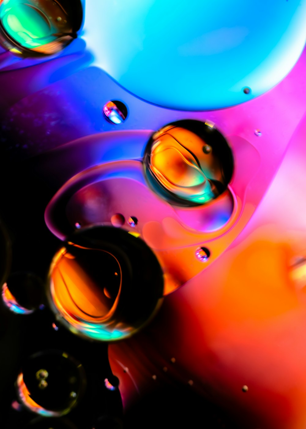 a close up of water droplets on a colorful surface