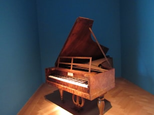 a grand piano in a room with blue walls