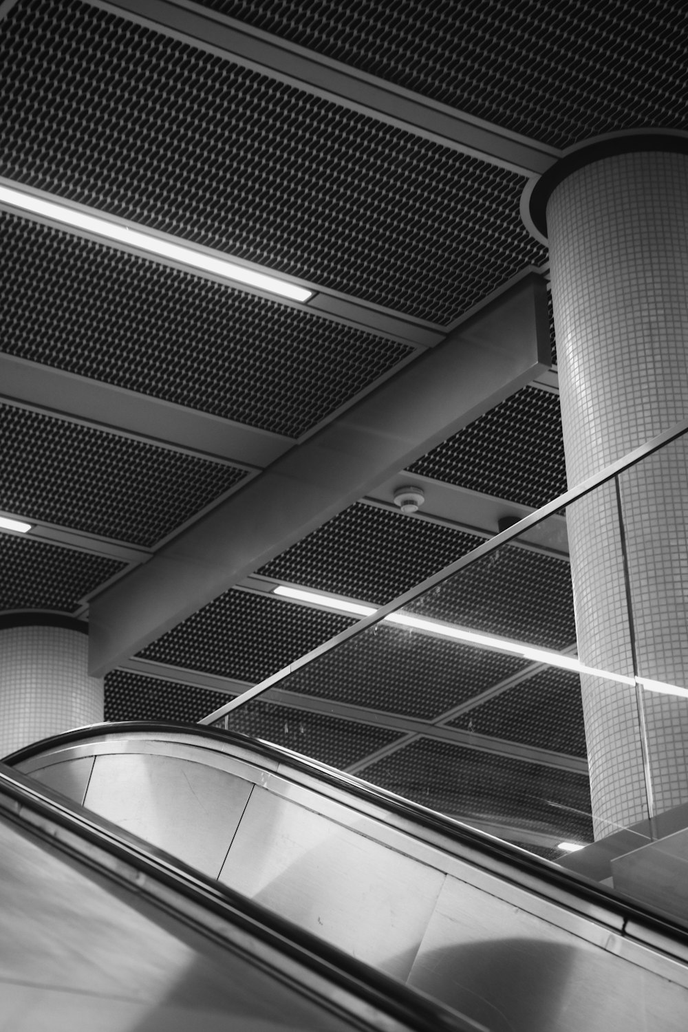 a black and white photo of an escalator