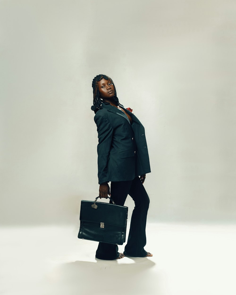 a woman in a suit holding a briefcase