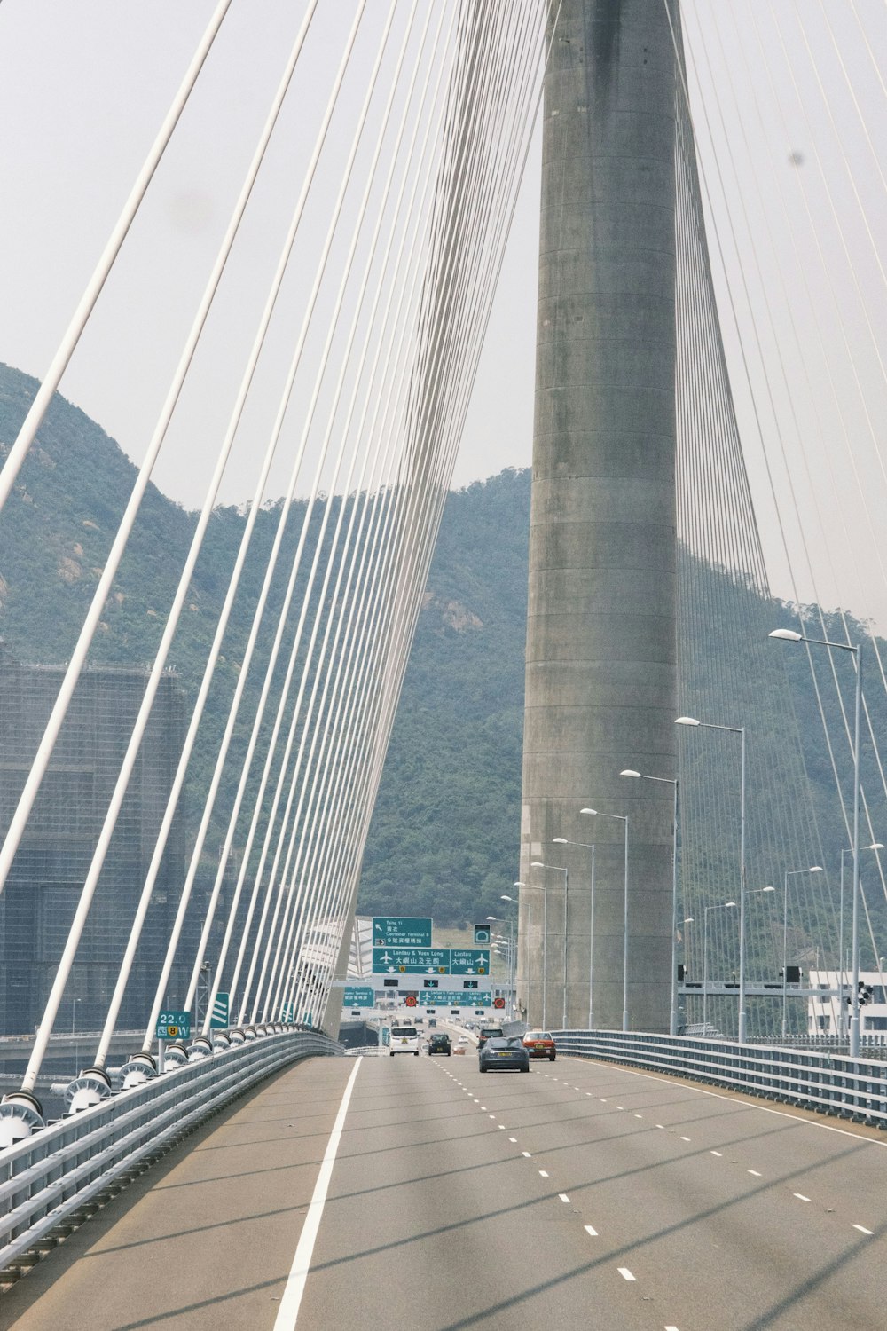 a view of a very tall bridge with cars driving on it
