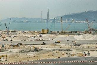 a construction site with a large body of water in the background