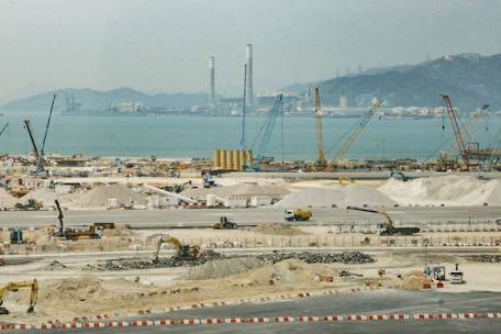 a construction site with a large body of water in the background
