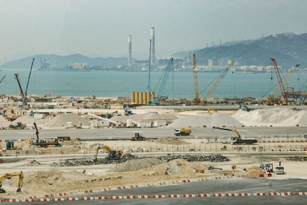 a construction site with a large body of water in the background