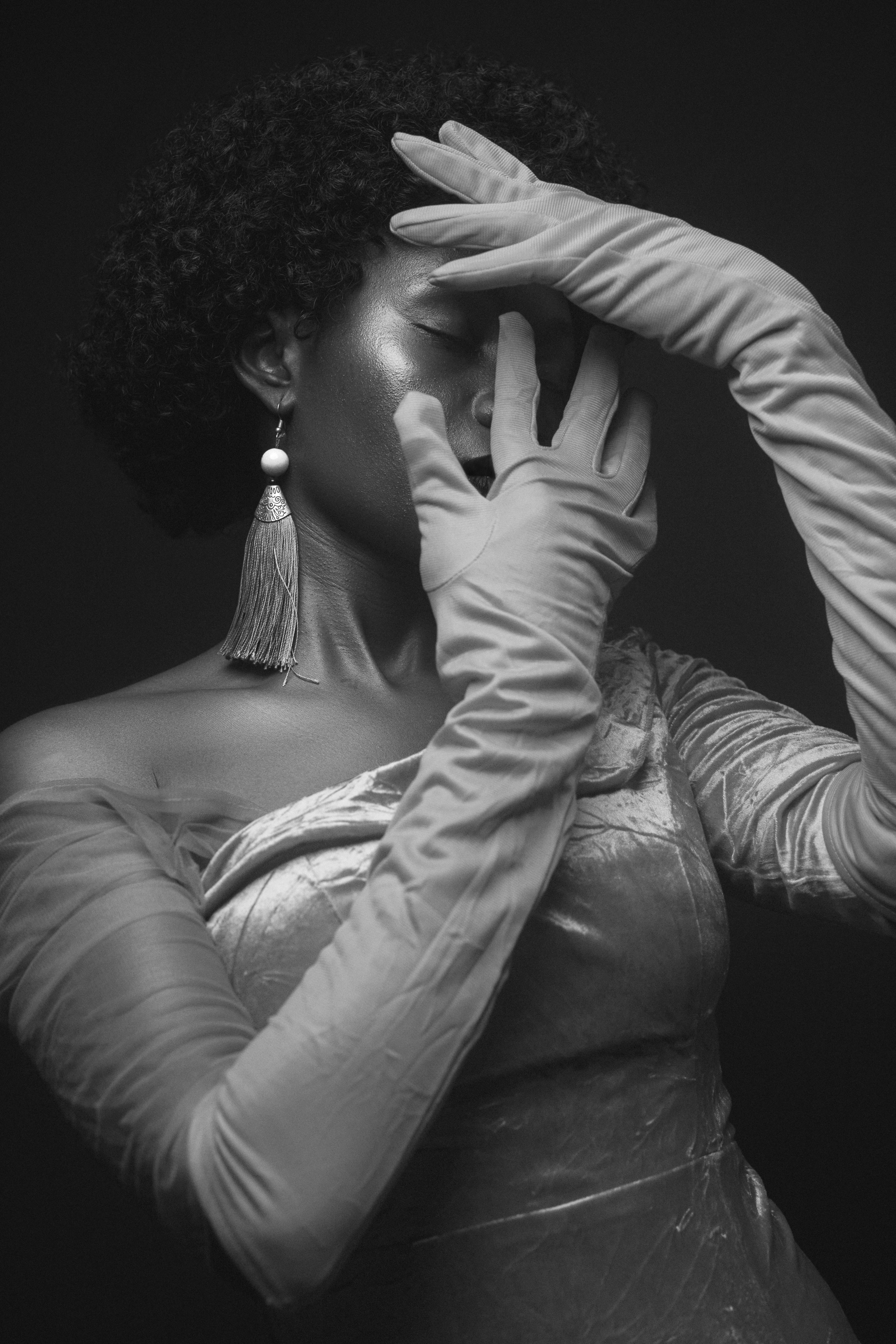 a woman in a white dress and long gloves